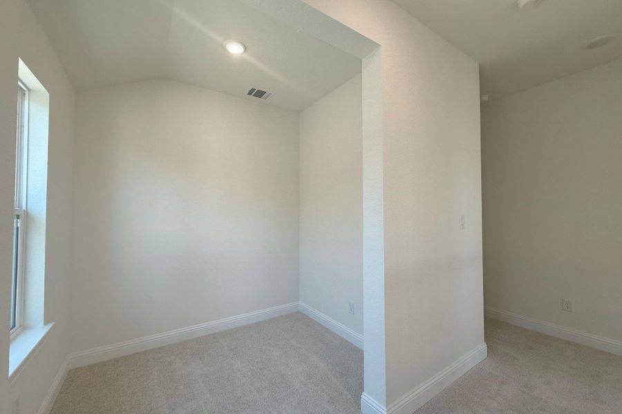 Alcove room with a single window, recessed lighting, and neutral-toned wall-to-wall carpeting