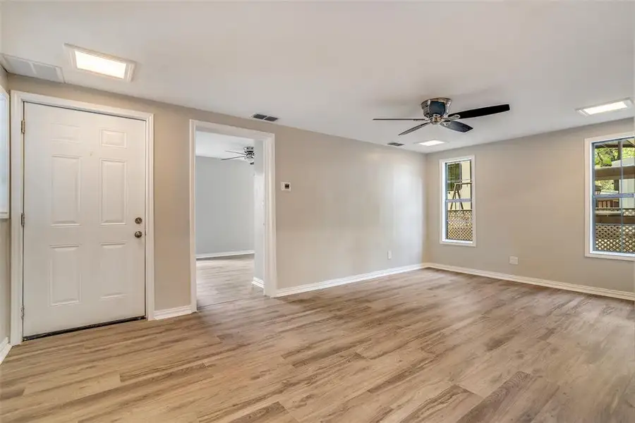 Unfurnished room with light wood-type flooring and ceiling fan Unfurnished room with light wood-type flooring and ceiling fan
