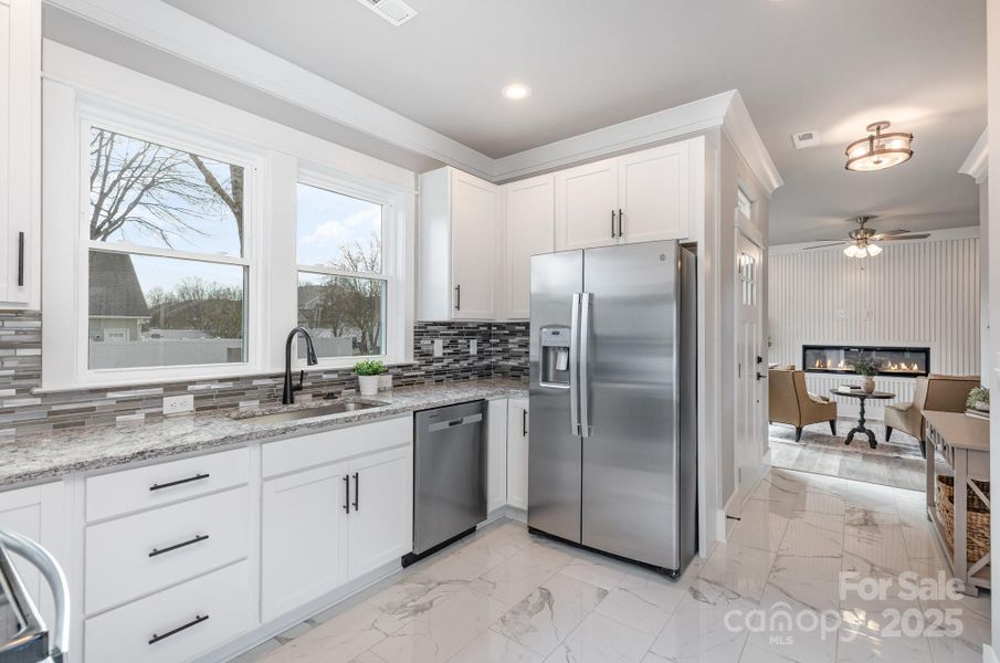 Kitchen looking into family room with electric fireplace