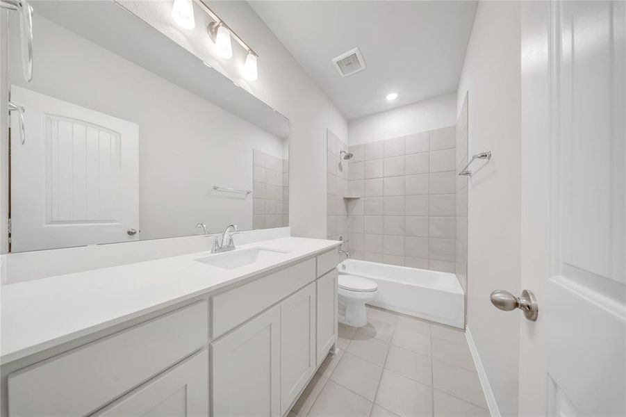Full bathroom featuring vanity, shower / washtub combination, recessed lighting, and tile patterned flooring Full bathroom featuring vanity, shower / washtub combination, recessed lighting, and tile patterned flooring