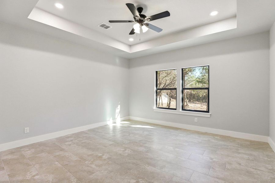 A quiet, generously proportioned bedroom with recessed lighting and a ceiling fan, ready for personal touches. A quiet, generously proportioned bedroom with recessed lighting and a ceiling fan, ready for personal touches.
