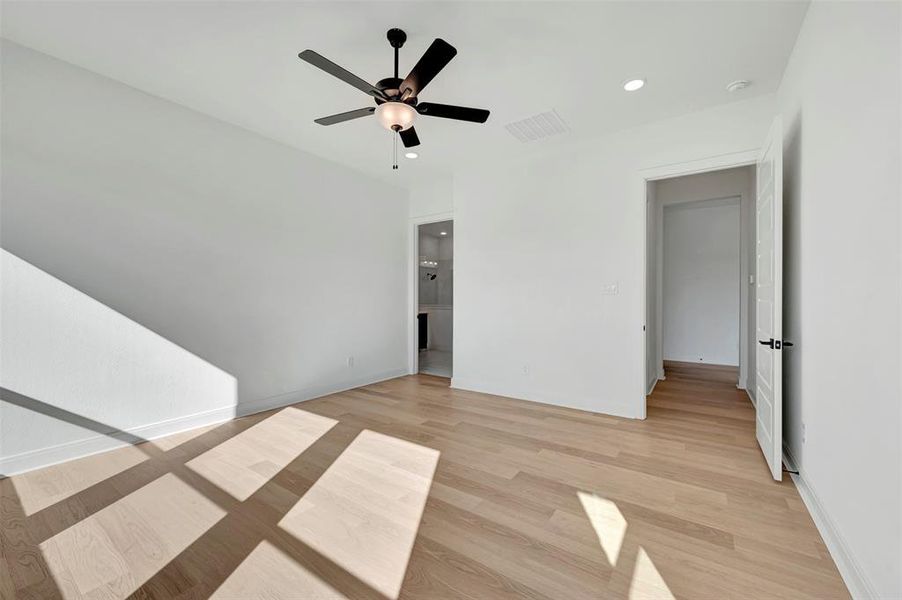 Unfurnished bedroom with light wood-style flooring, ceiling fan, and recessed lighting Unfurnished bedroom with light wood-style flooring, ceiling fan, and recessed lighting