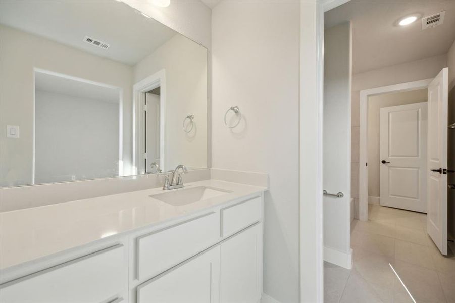 Bathroom with tile patterned flooring and vanity