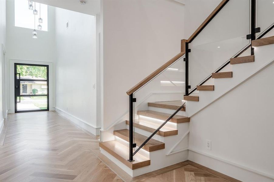 Foyer with healthy amount of natural light, stairs, and a high ceiling Foyer with healthy amount of natural light, stairs, and a high ceiling