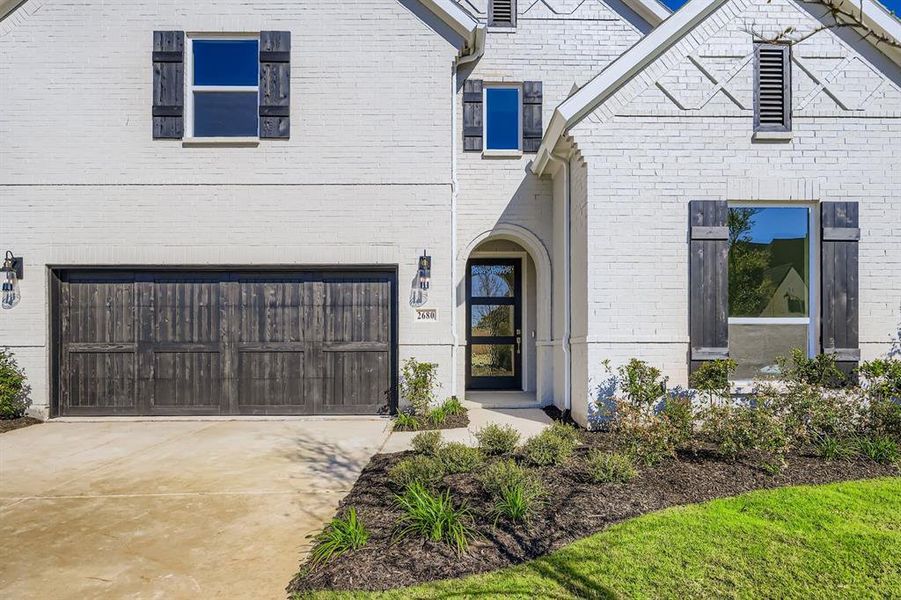 View of front of house with a garage, brick siding, and concrete driveway View of front of house with a garage, brick siding, and concrete driveway