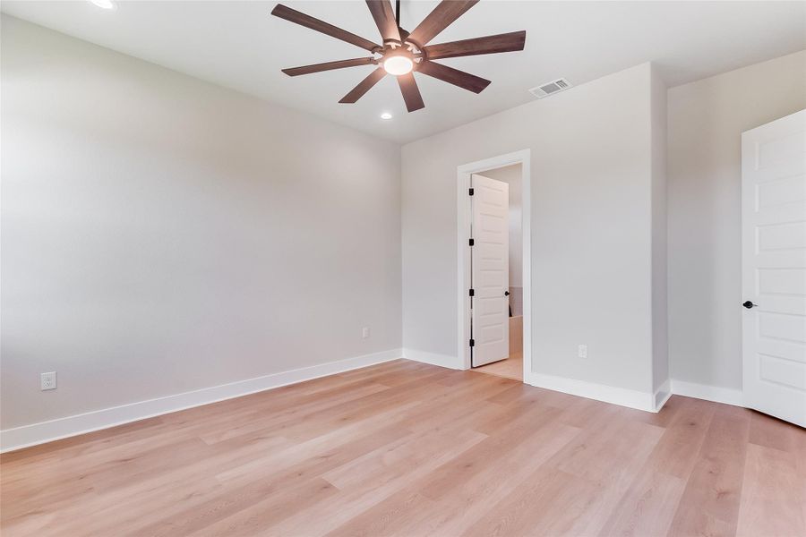 Unfurnished bedroom featuring light wood-style floors, a ceiling fan, and recessed lighting