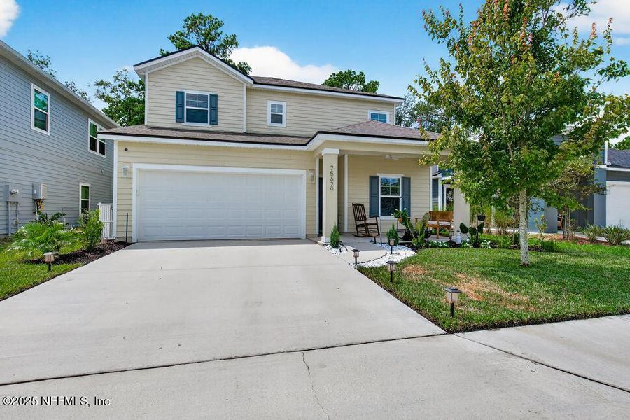 Front exterior of a new home in Tributary, Yulee, FL, highlighting curb appeal (Image 2).