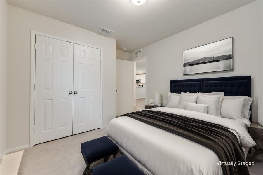 Bedroom featuring light colored carpet and a closet