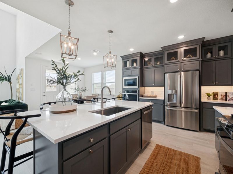 Stylish kitchen with grey stacked cabinets and quartz counters (*Photo not of actual home and used for illustration purposes only.)