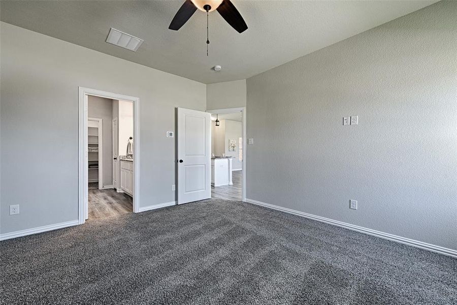 Primary bedroom with ensuite bath - Iron Lodge Color Collection in this example