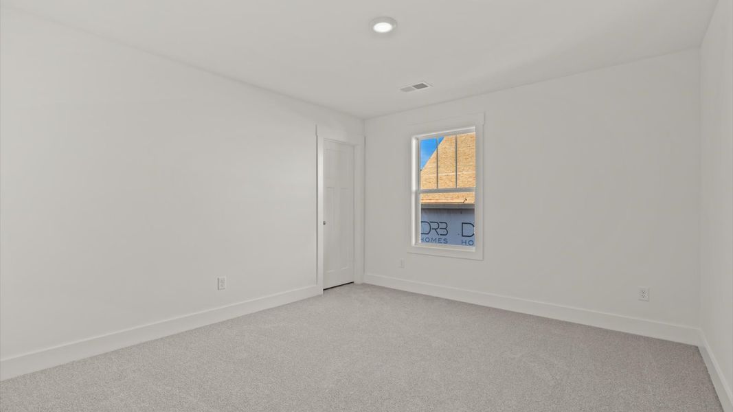 Vibrant and restful bedroom with oversized windows, refined detail, and a warm, welcoming atmosphere