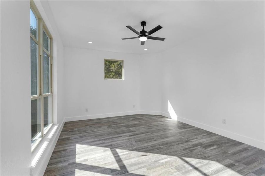 Spare room with ceiling fan and dark hardwood / wood-style flooring