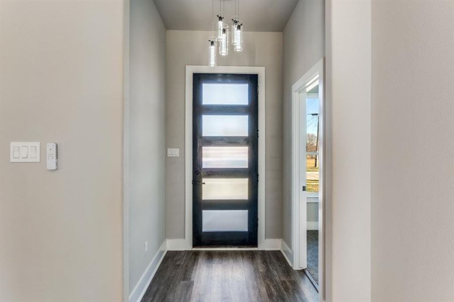 Entrance foyer featuring dark wood-type flooring and baseboards