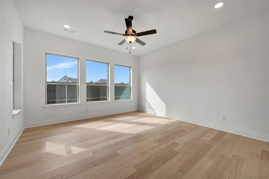 Unfurnished room with light wood-type flooring, ceiling fan, and recessed lighting Unfurnished room with light wood-type flooring, ceiling fan, and recessed lighting
