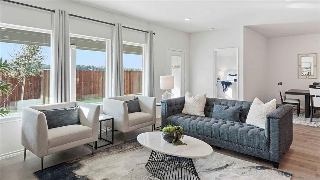 Living room with wood finished floors and recessed lighting