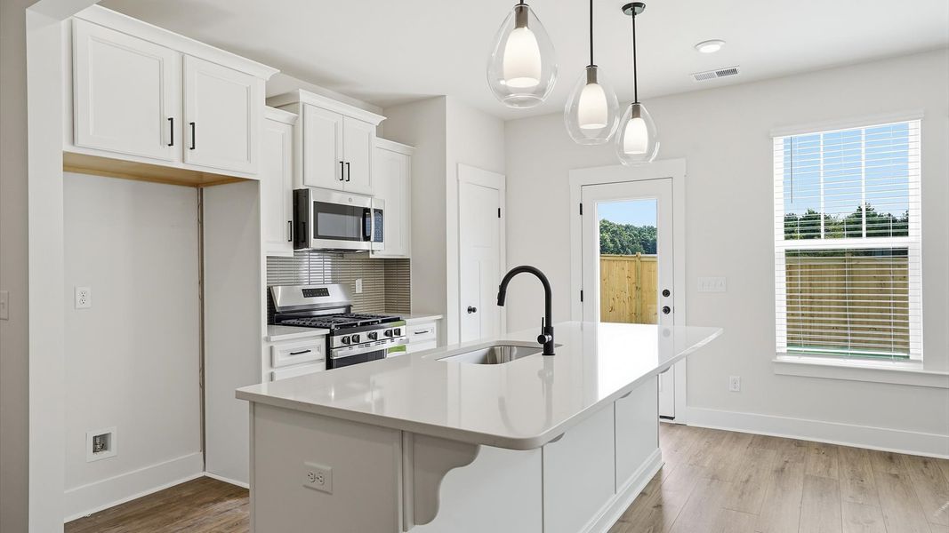 Accomplished design in a kitchen that blends function and form with a right-sized island in Fountain Inn, SC Accomplished design in a kitchen that blends function and form with a right-sized island in Fountain Inn, SC