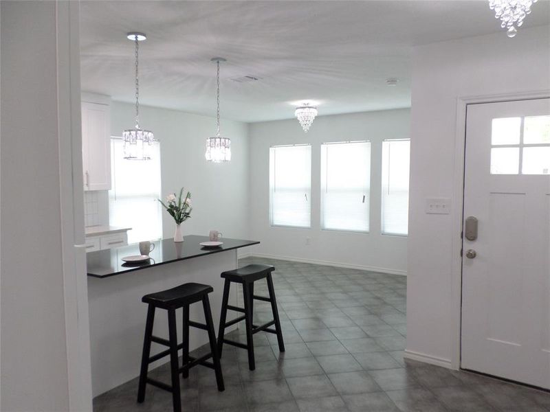 Kitchen island with a dark countertop and two pendant lights