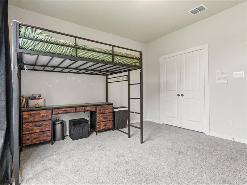 Comfortable secondary bedroom faces the street, with natural light