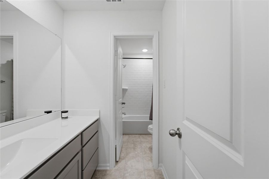 A well-appointed bathroom boasts a broad vanity and a separate tub and shower combination. A well-appointed bathroom boasts a broad vanity and a separate tub and shower combination.