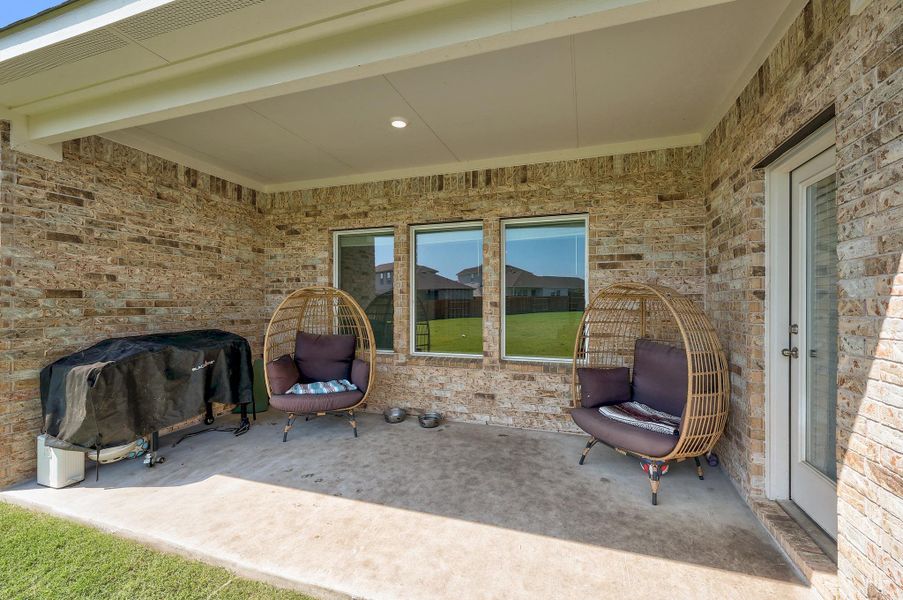 Covered patio featuring a concrete slab and brick exterior Covered patio featuring a concrete slab and brick exterior