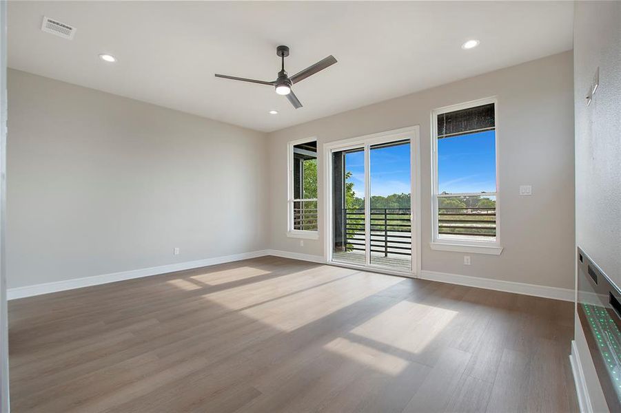 Empty room featuring ceiling fan and wood-type flooring