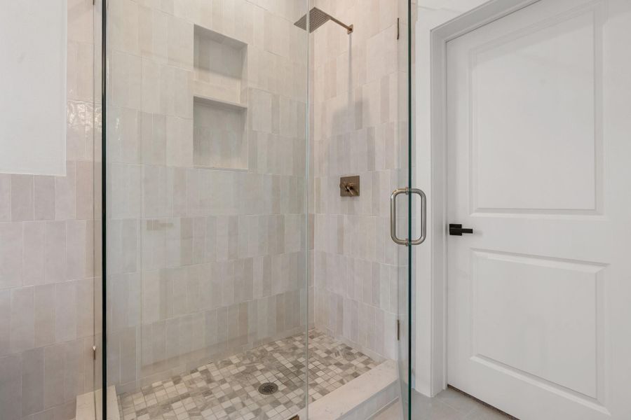 This stunning shower showcases sleek frameless glass doors, designer-style finishes, and a built-in niche - offering both elegance and convenience in a beautifully crafted spa-like retreat. This stunning shower showcases sleek frameless glass doors, designer-style finishes, and a built-in niche - offering both elegance and convenience in a beautifully crafted spa-like retreat.