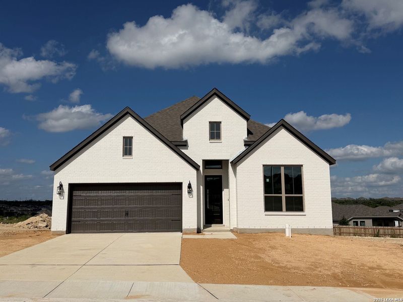 Front exterior of a new home in Ladera - 50s, San Antonio, TX, highlighting curb appeal (Image 1). Front exterior of a new home in Ladera - 50s, San Antonio, TX, highlighting curb appeal (Image 1).