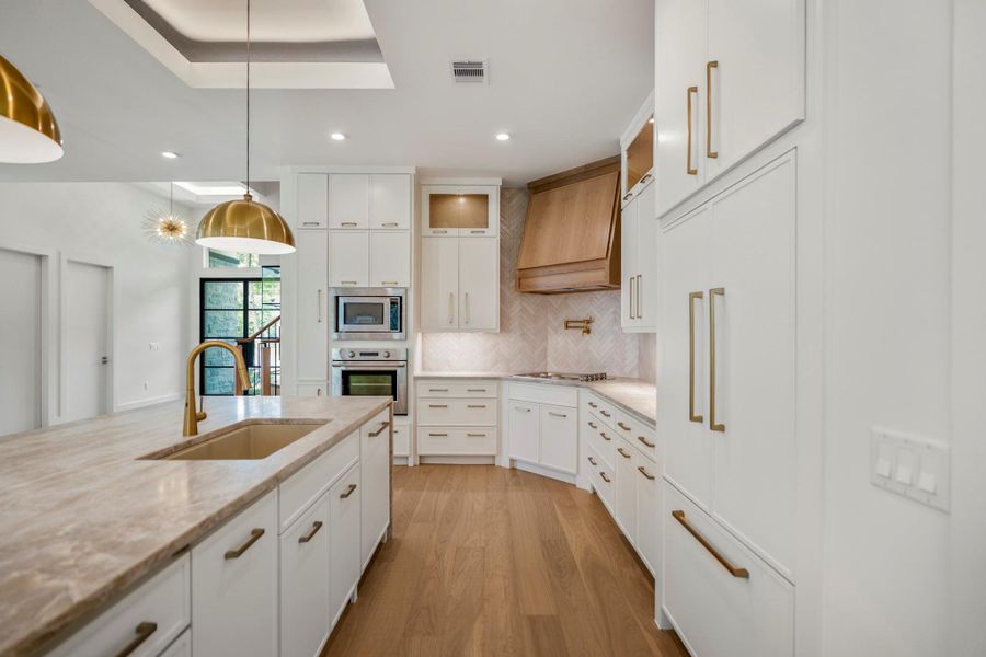 Extra wide kitchen walk way was carefully curated to accommodate the chef, sous chef and tiny helpers. Gorgeous paneled dishwasher and Fisher and Paykel Refrigerator give a more luxurious experience. Extra wide kitchen walk way was carefully curated to accommodate the chef, sous chef and tiny helpers. Gorgeous paneled dishwasher and Fisher and Paykel Refrigerator give a more luxurious experience.