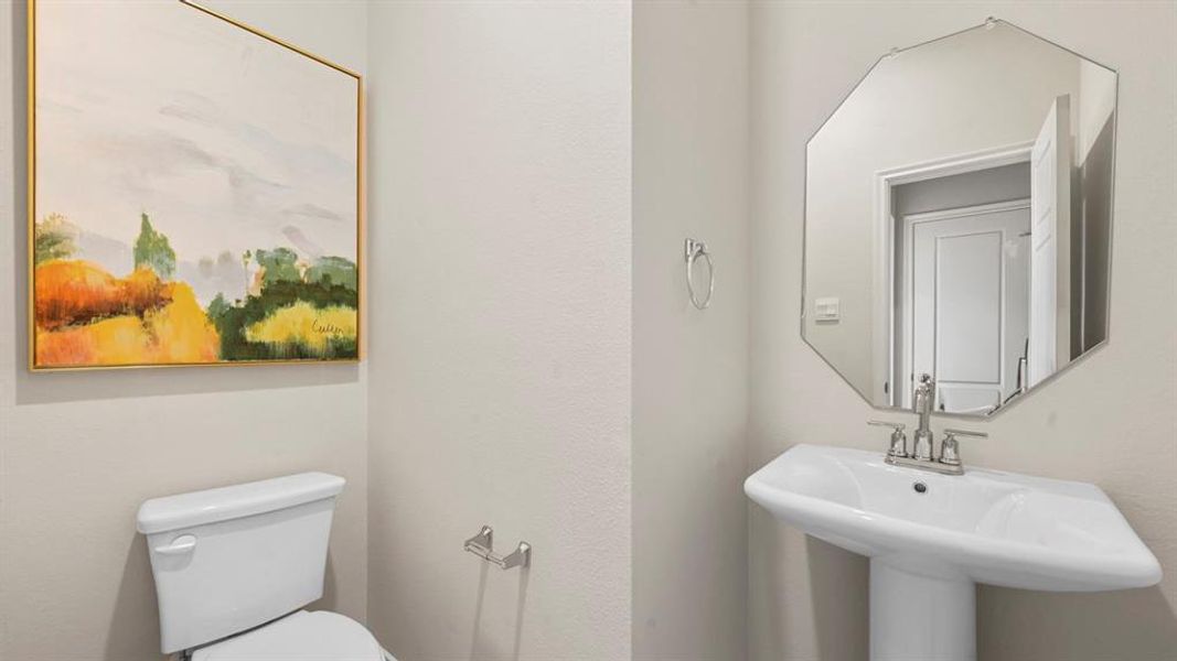Bathroom featuring toilet and a sink Bathroom featuring toilet and a sink
