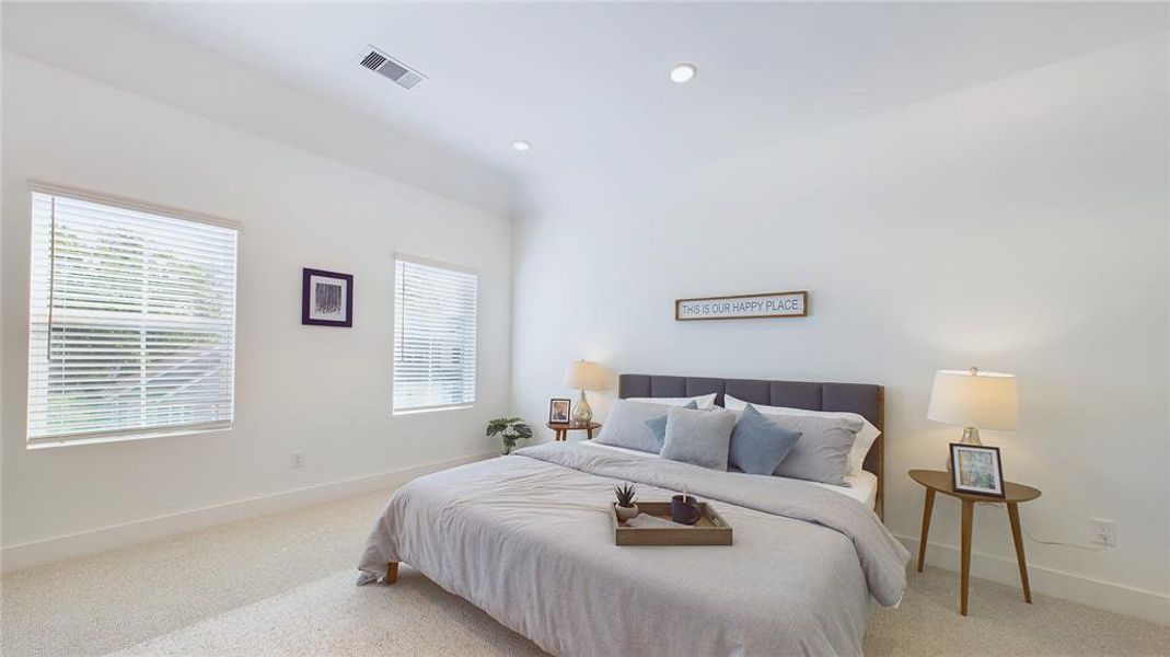 Elegant & spacious primary bedroom located on the 2nd floor. The high ceilings, with recessed lighting, are prewired and blocked for ceiling fans (not included).