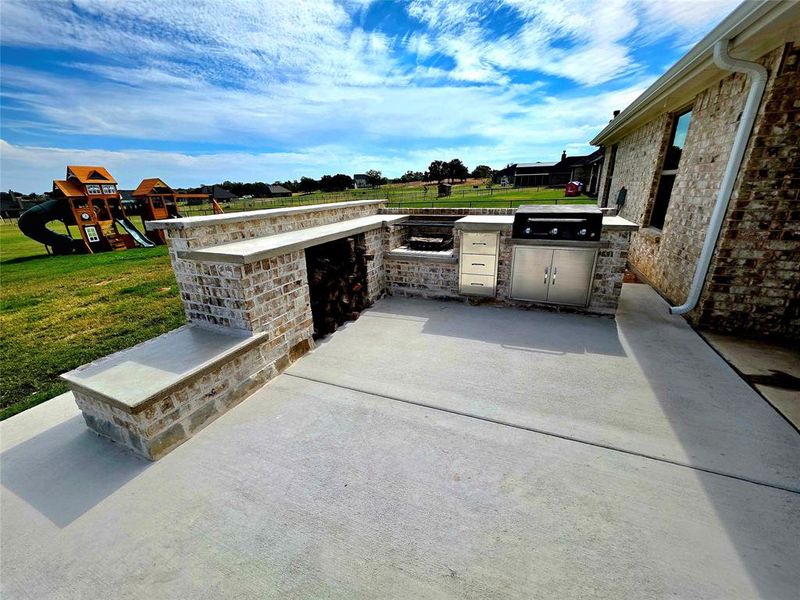 View of patio / terrace with exterior kitchen and a playground