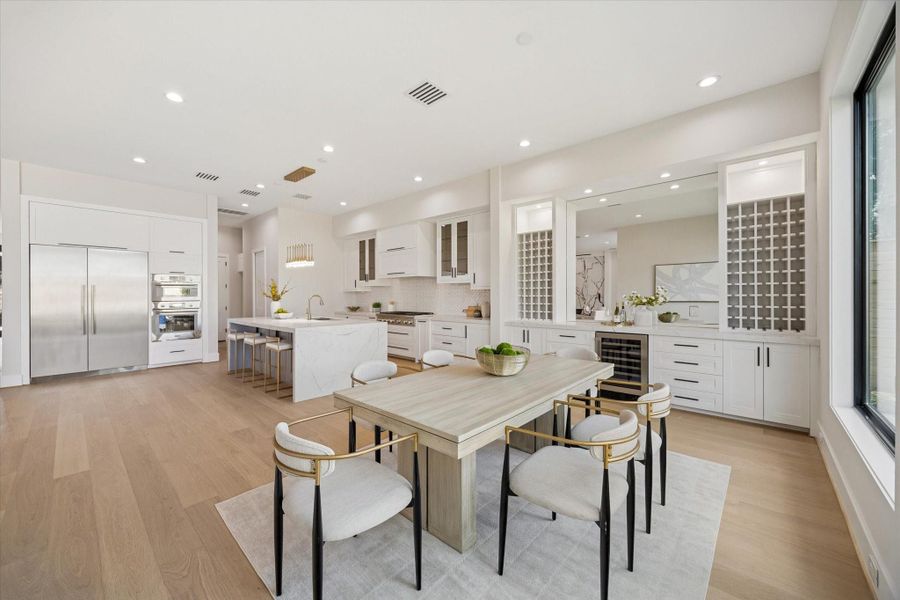 The dining room is designed for hosting lavish dinners and special occasions, with ample space to accommodate a large dining table and chairs.  The buffet area is both stylish and functional, offering dedicated wine storage, ample drawer and cabinet space for organization, and a built-in beverage cooler for convenience.