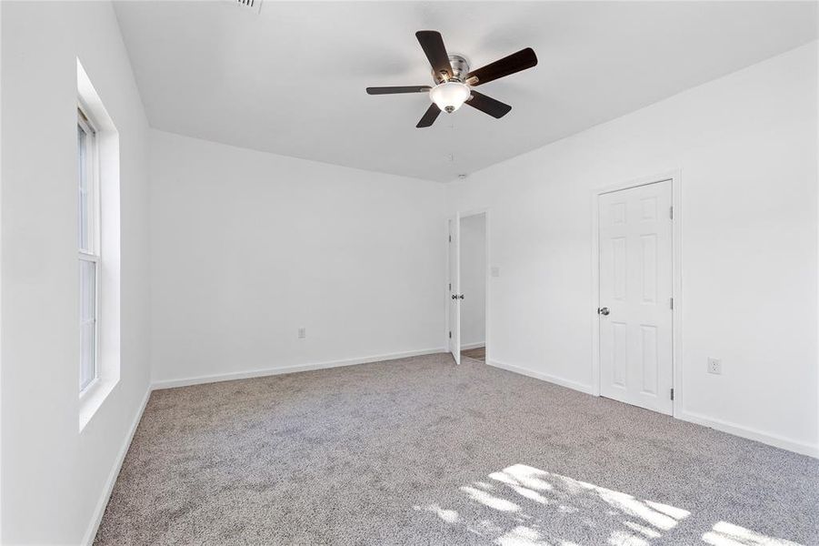 Unfurnished bedroom with carpet floors and ceiling fan Unfurnished bedroom with carpet floors and ceiling fan