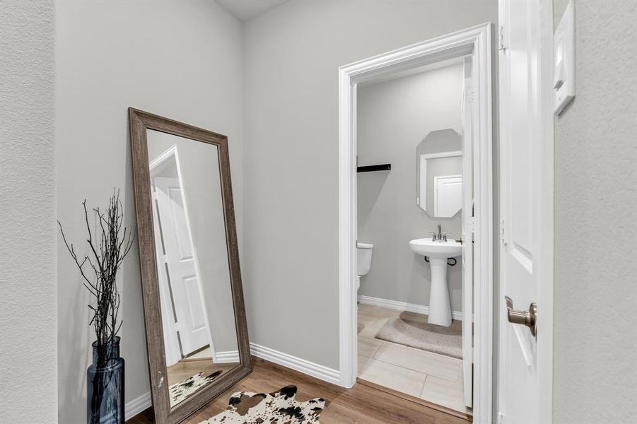 Bathroom with sink and wood-type flooring