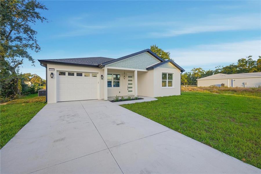 Front exterior of a new home in , Belleview, FL, highlighting curb appeal (Image 16).
