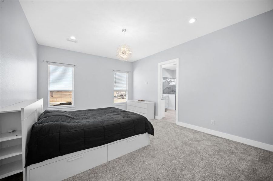 Bedroom featuring carpet and a chandelier