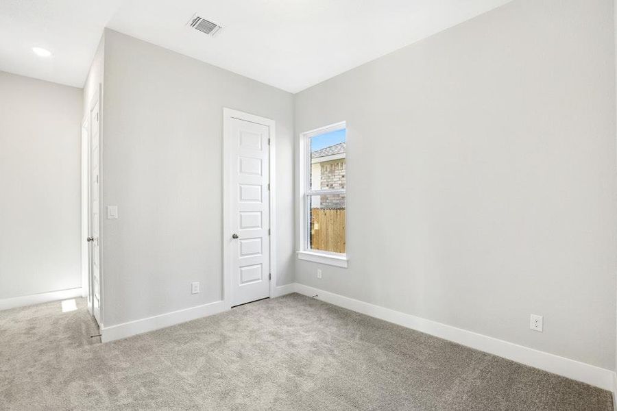 Unfurnished bedroom featuring light carpet and baseboards Unfurnished bedroom featuring light carpet and baseboards