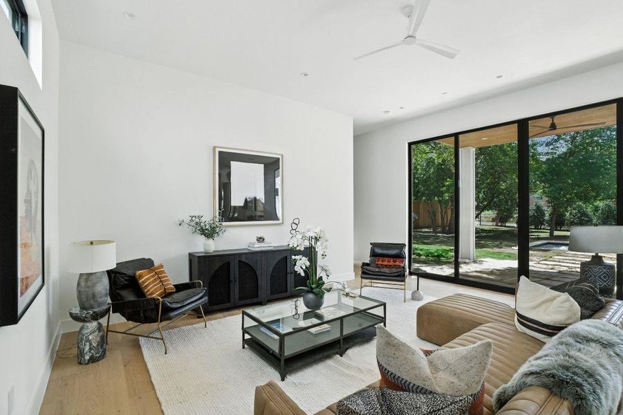 Living area with wood finished floors and ceiling fan Living area with wood finished floors and ceiling fan