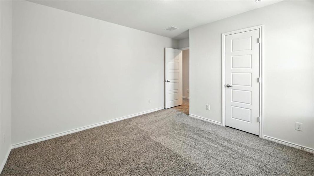 Unfurnished bedroom featuring carpet and baseboards