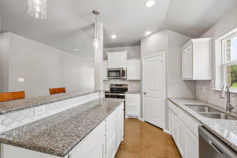 Granite countertops and stainless steel appliances elevate this bright, well-appointed kitchen. Granite countertops and stainless steel appliances elevate this bright, well-appointed kitchen.