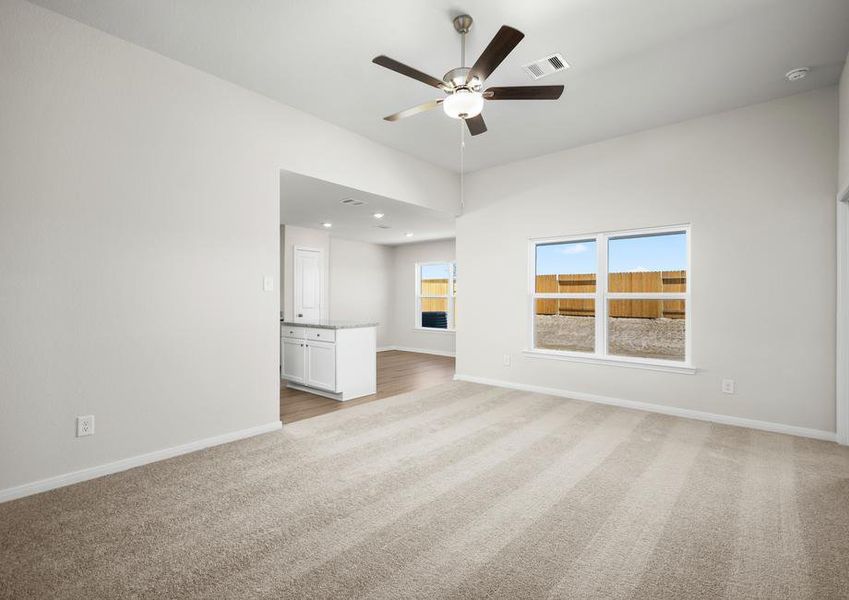 The spacious living room with carpet.