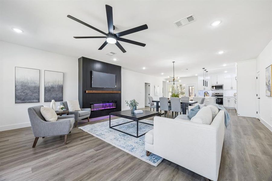 Living area with ceiling fan and an electric fireplace