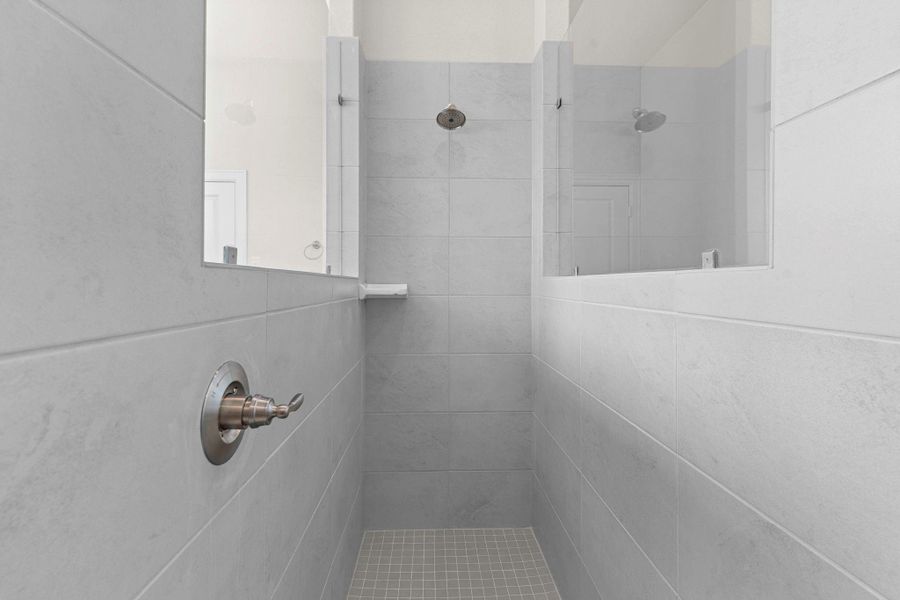 Spacious walk-in shower with sleek tile surround, and premium fixtures, blending modern design with comfort. Spacious walk-in shower with sleek tile surround, and premium fixtures, blending modern design with comfort.