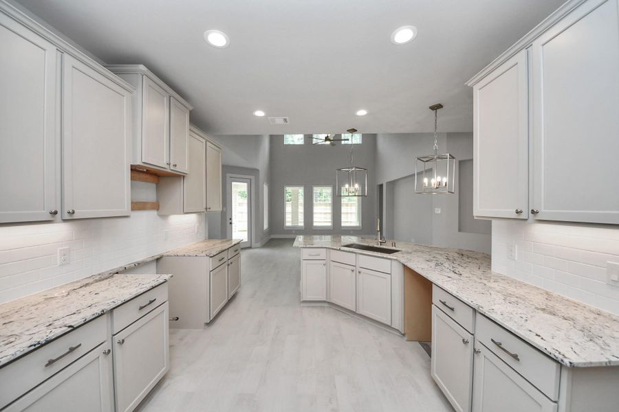 This kitchen is by far any chef’s dream! This spacious kitchen features high ceilings, light stained wood cabinets, granite countertop, SS appliances, modern tile backsplash, recessed lighting, extended counter space, and a walk-in pantry all overlooking your huge family room. This kitchen is by far any chef’s dream! This spacious kitchen features high ceilings, light stained wood cabinets, granite countertop, SS appliances, modern tile backsplash, recessed lighting, extended counter space, and a walk-in pantry all overlooking your huge family room.