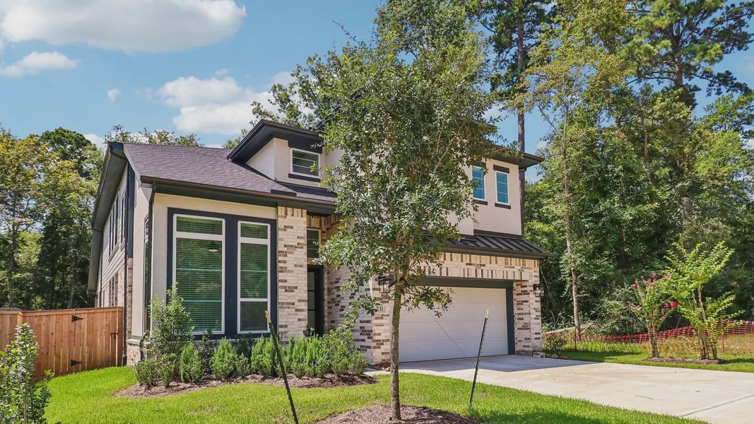 Front exterior of a new home in The Woodland Hills 50', Willis, TX, highlighting curb appeal (Image 2). Front exterior of a new home in The Woodland Hills 50', Willis, TX, highlighting curb appeal (Image 2).