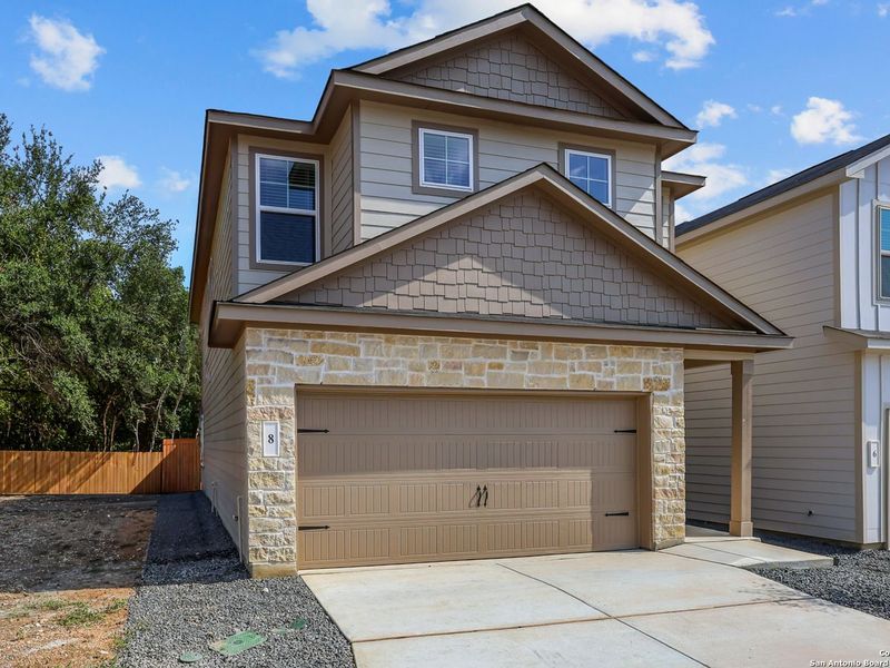 Front exterior of a new home in Cedar Heights, San Antonio, TX, highlighting curb appeal (Image 2). Front exterior of a new home in Cedar Heights, San Antonio, TX, highlighting curb appeal (Image 2).