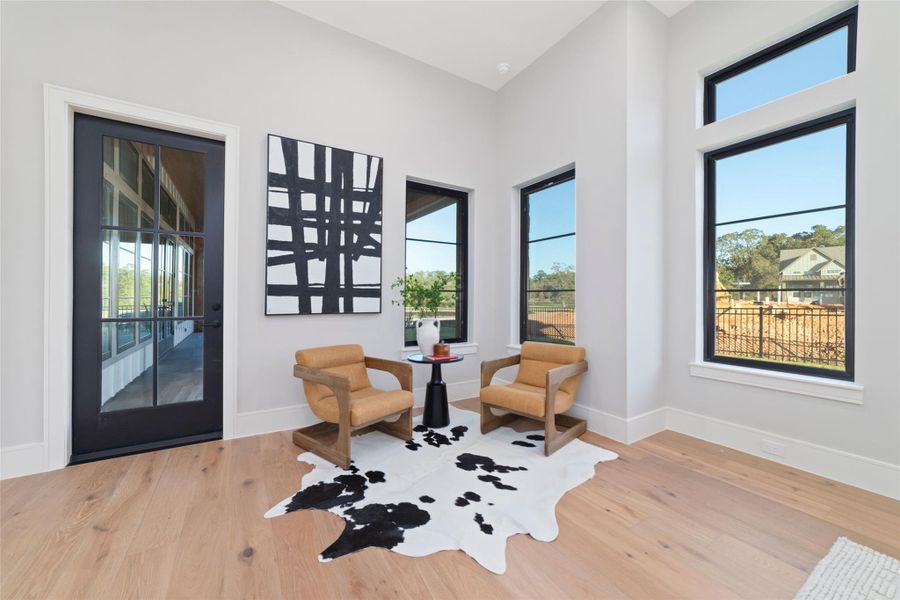 The primary bedroom has a sitting area with access to the covered back patio.