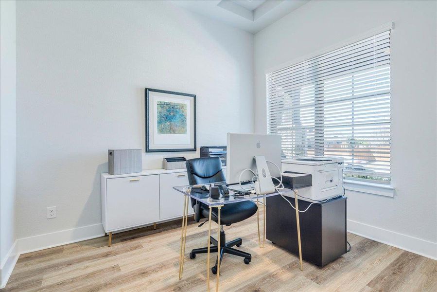 Home office with light wood-style floors Home office with light wood-style floors