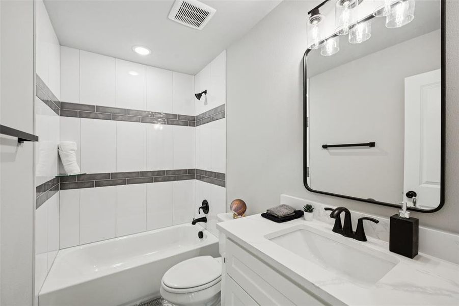 Full bathroom with shower / tub combination, vanity, and recessed lighting