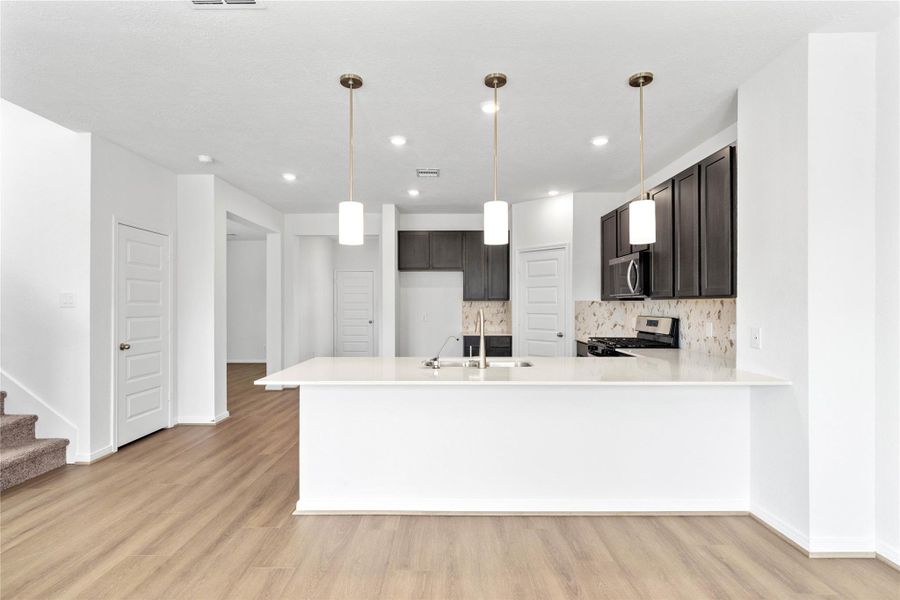 This spacious kitchen has it all—ample storage, generous counter space, and a layout that truly makes it the heart of the home.